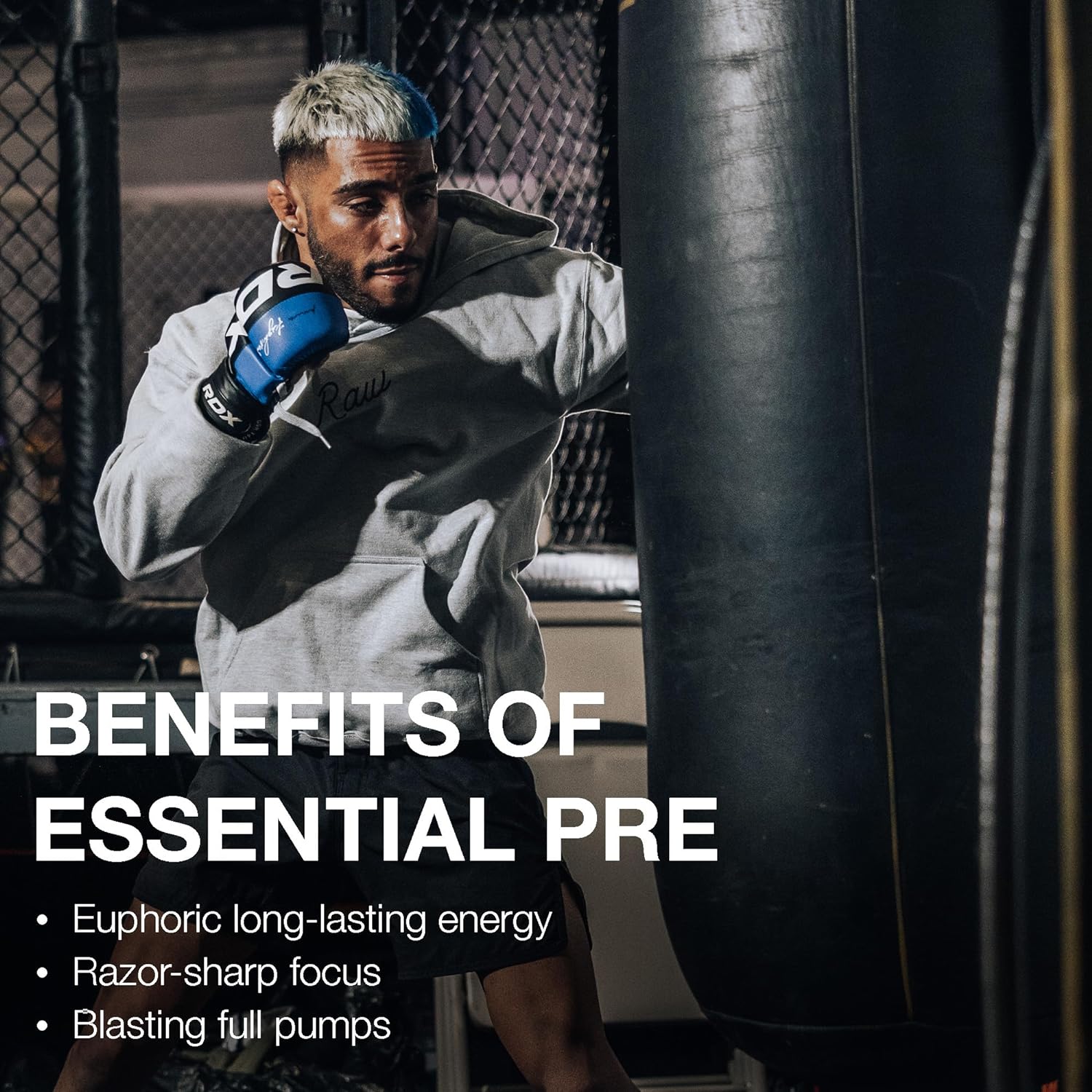 Male fighter with blue blonde hair, wearing grey hoodie, MMA gloves, fighting fatigue with Raw Nutrition Essential PRE