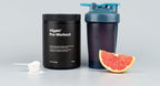 Vilgain Pre-Workout 2.0 black tub with powder scoop, shaker, and grapefruit slice