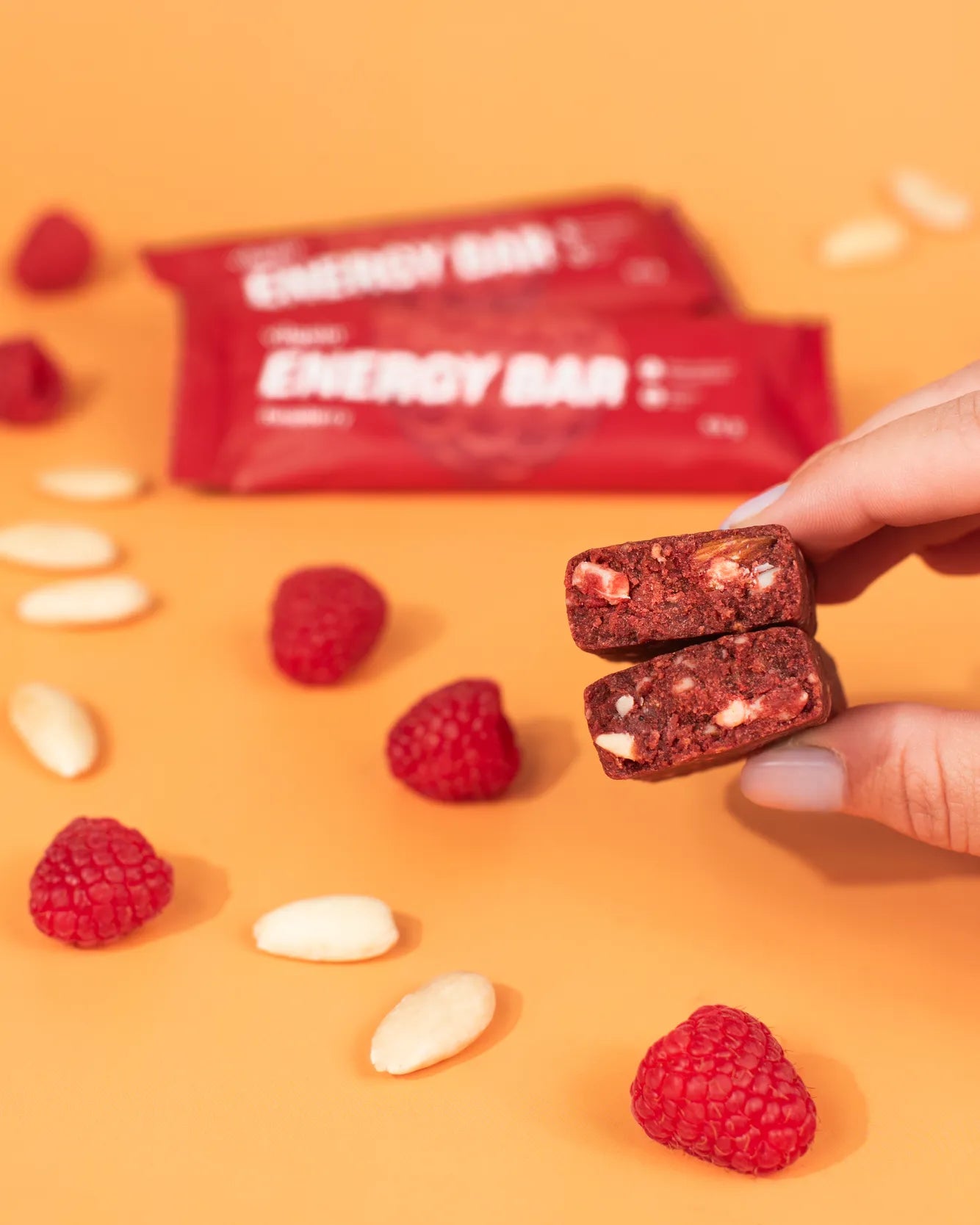 Person holding two halves of Vilgain Energy Bar with Vilgain clean formula and meaningful ingredients