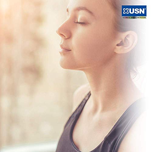 Woman in black tank top meditating with USN Ashwagandha root extract for calmness