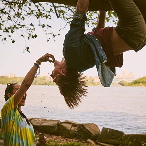 Nature Valley Crunchy cereal bars scene with person hanging upside down from a tree