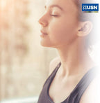 Woman in black sports top with eyes closed, enjoying tranquility with USN Ashwagandha root extract