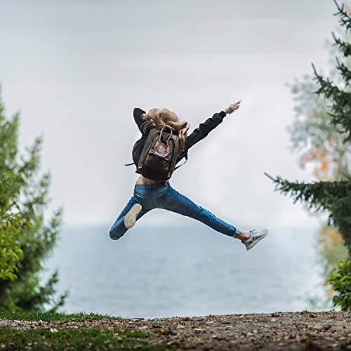 Young woman jumping in air with backpack wearing dark jacket and jeans for Nature Valley Protein