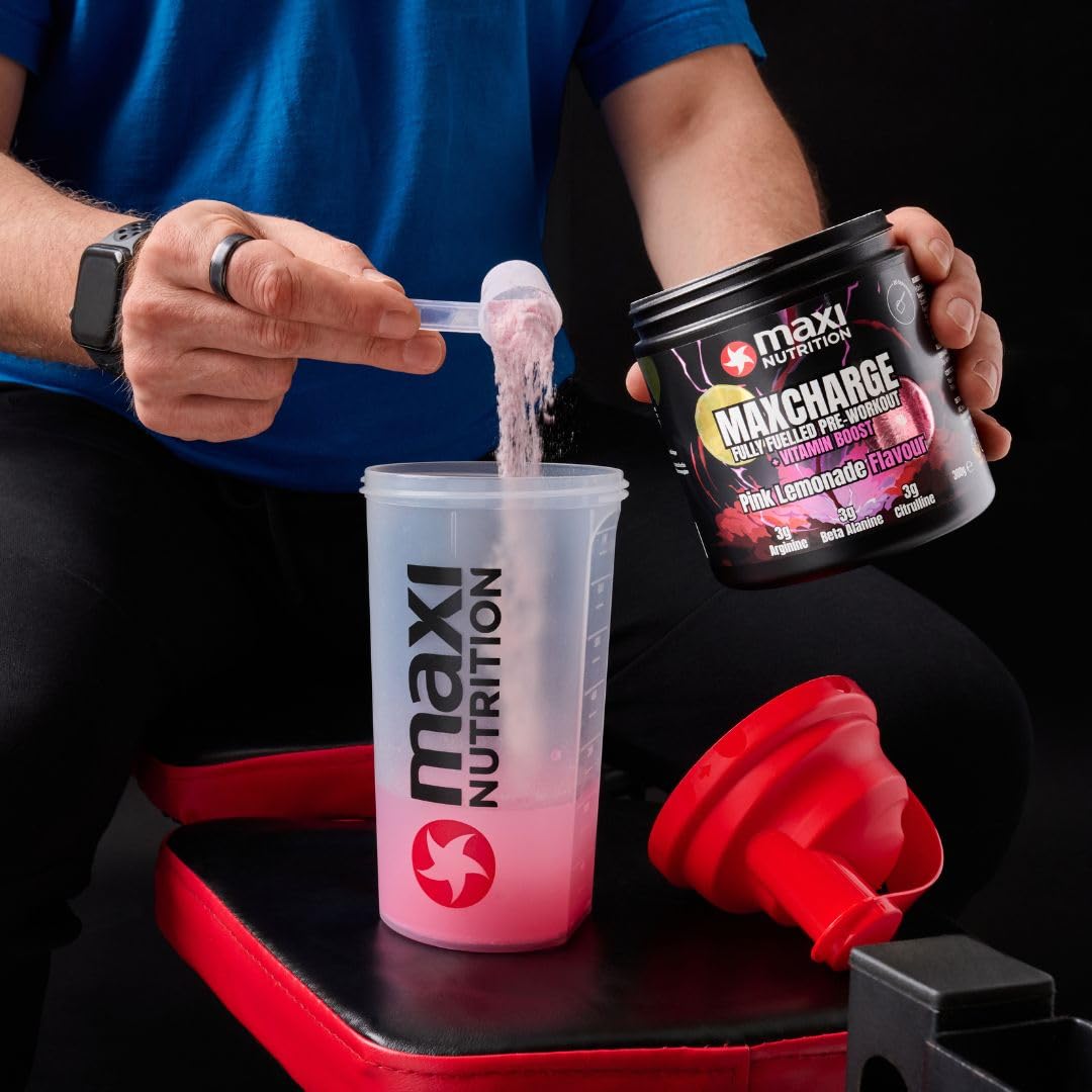 Pink lemonade flavored charge vitamin boosted pre-workout powder being poured into a shaker bottle for Maxi Nutrition Max Charge Vitamin Boosted Pre-Workout