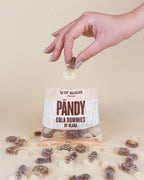 PANDY Candy cola-flavored gummy candies with a gummy being dropped into the bag
