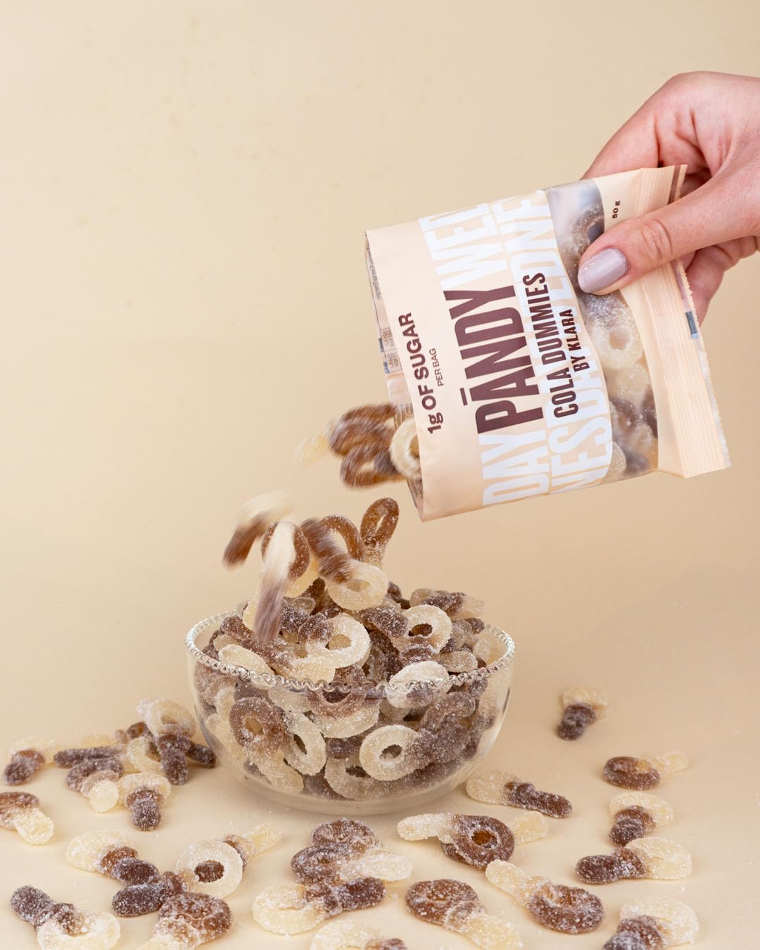 PANDY Candy cola-flavored gummy candies poured into a bowl, perfect with peach rings or fizzy bottles