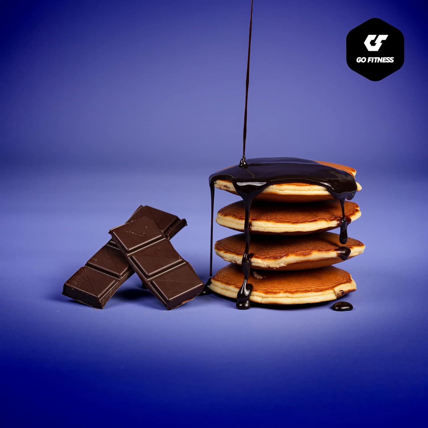 Delicious whipped protein soft pancakes with dark chocolate syrup and chocolate bars