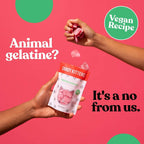Pink cat-shaped gummy candies from Candy Kittens 10x140g Wanderlust being poured into a hand