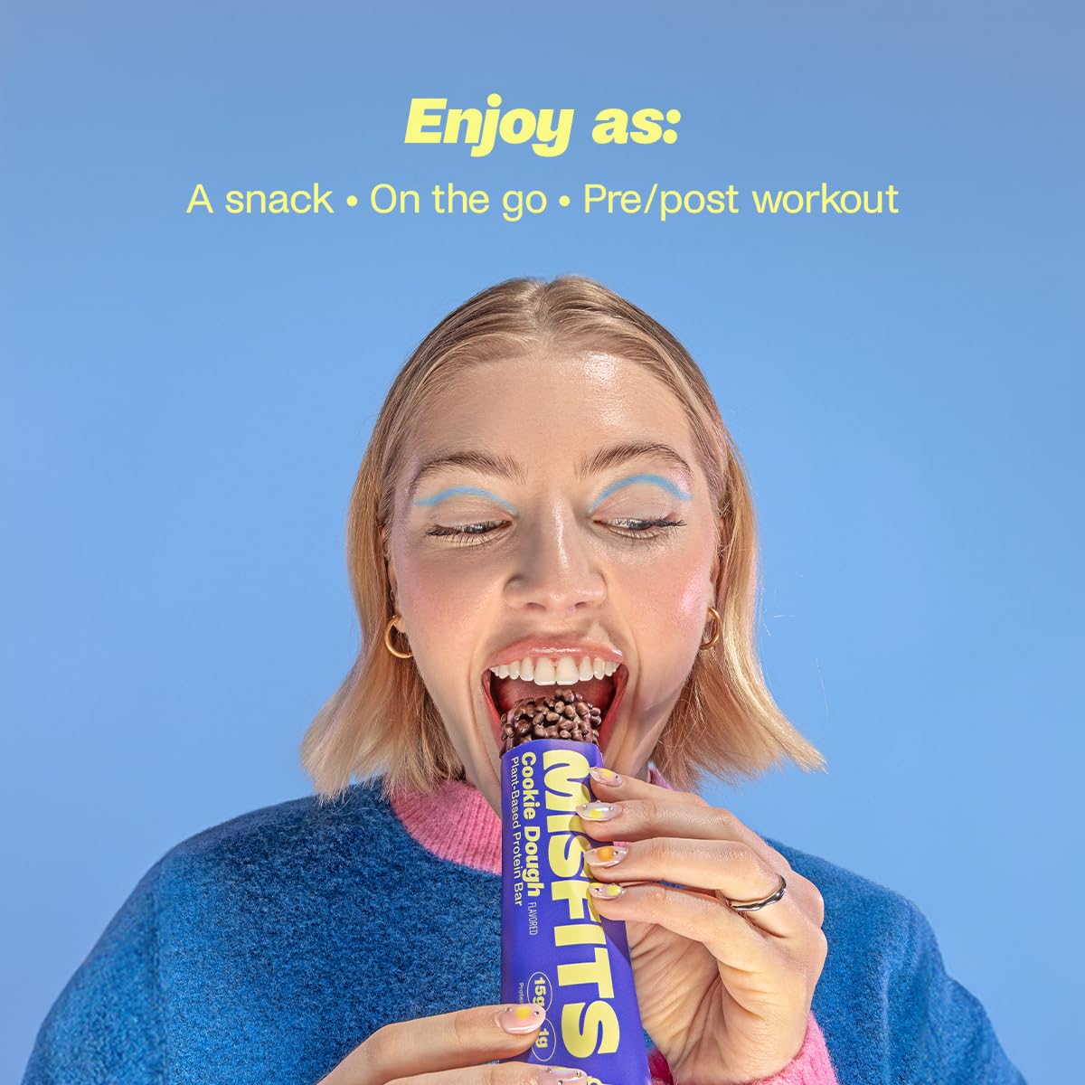 Woman enjoying a Misfits Plant-Based Protein Bar, healthy plant-based protein snack