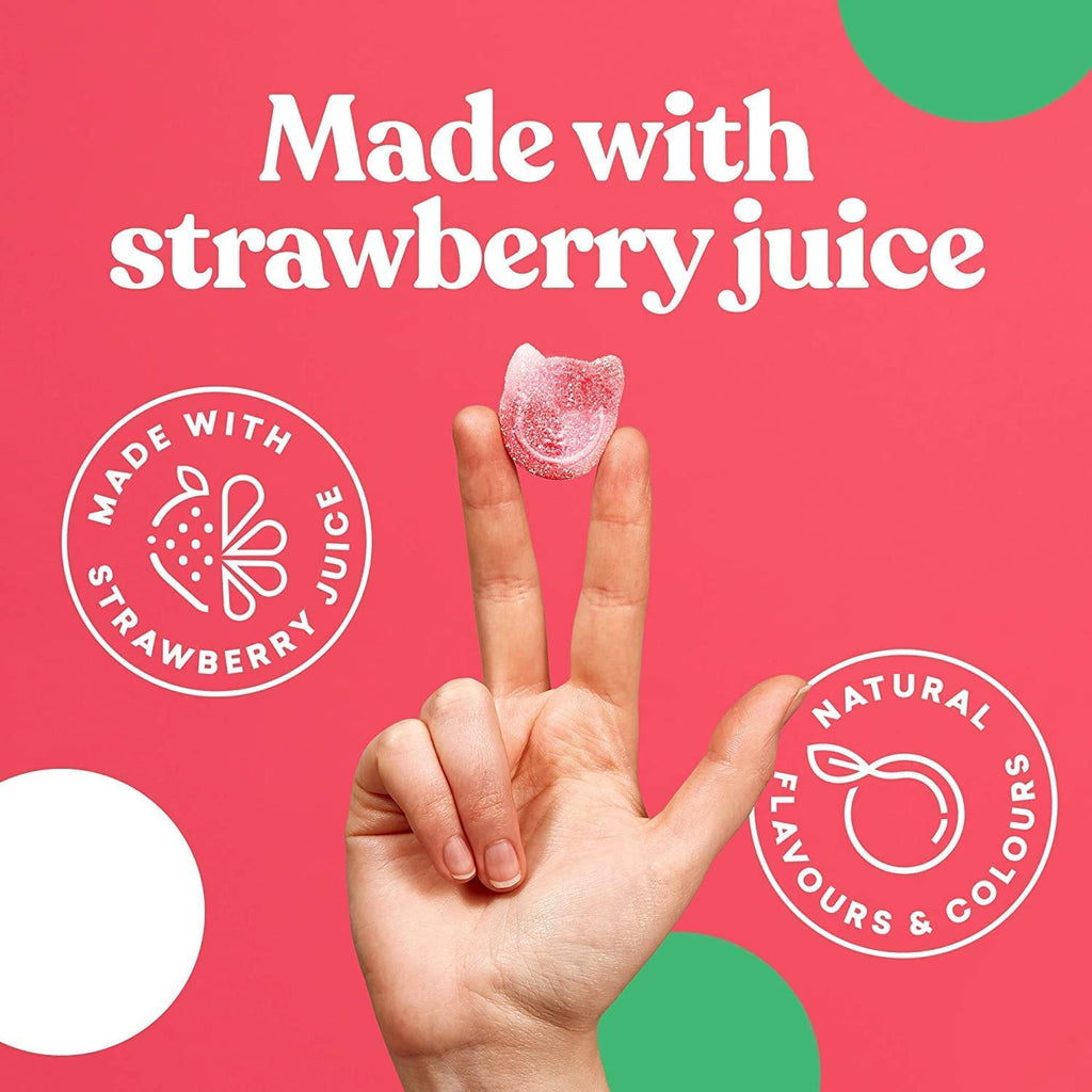 Pink cat-shaped gummy candy from Candy Kittens 10x140g Wanderlust held between fingers