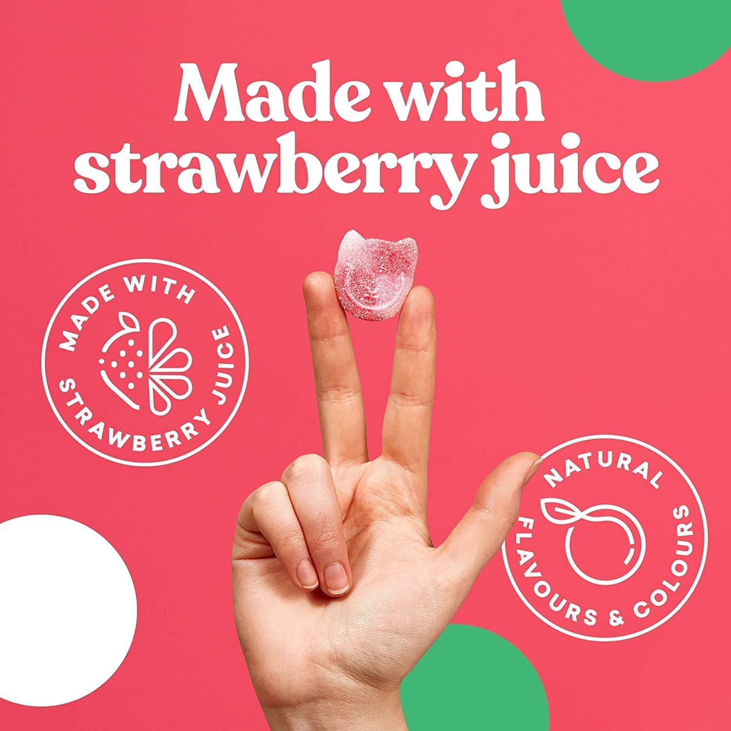 Pink cat-shaped gummy candy from Candy Kittens 10x140g Wanderlust held between fingers