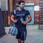 Man in athletic wear holding a duffel bag and water bottle with RIPT Contrast Performance T-Shirt XL