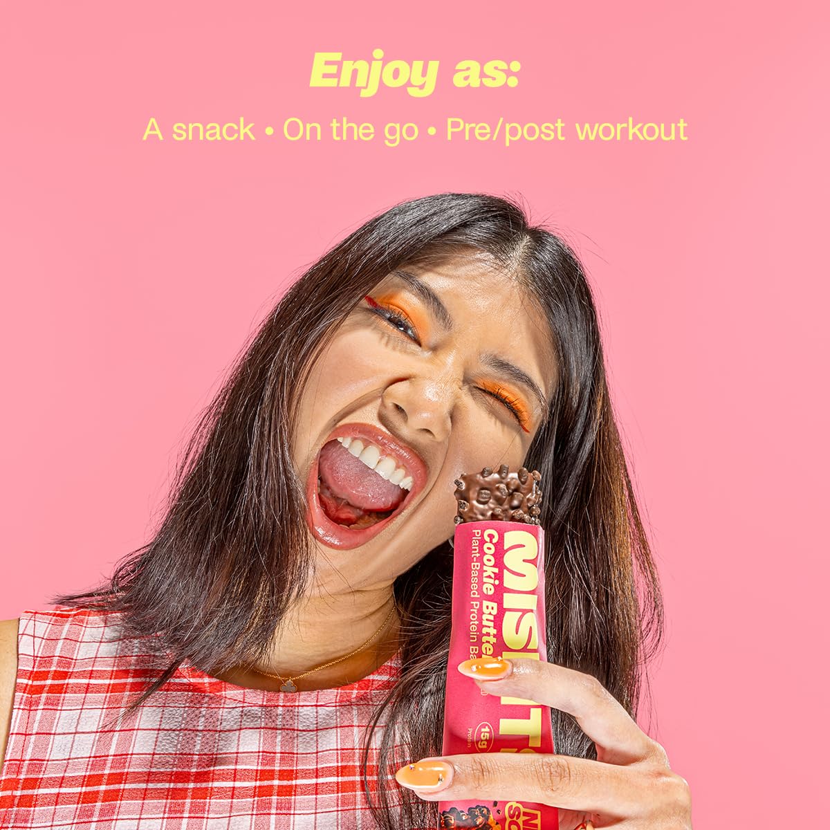 Woman holding Misfits Plant-Based Protein Bar with chocolate cookie butter flavor