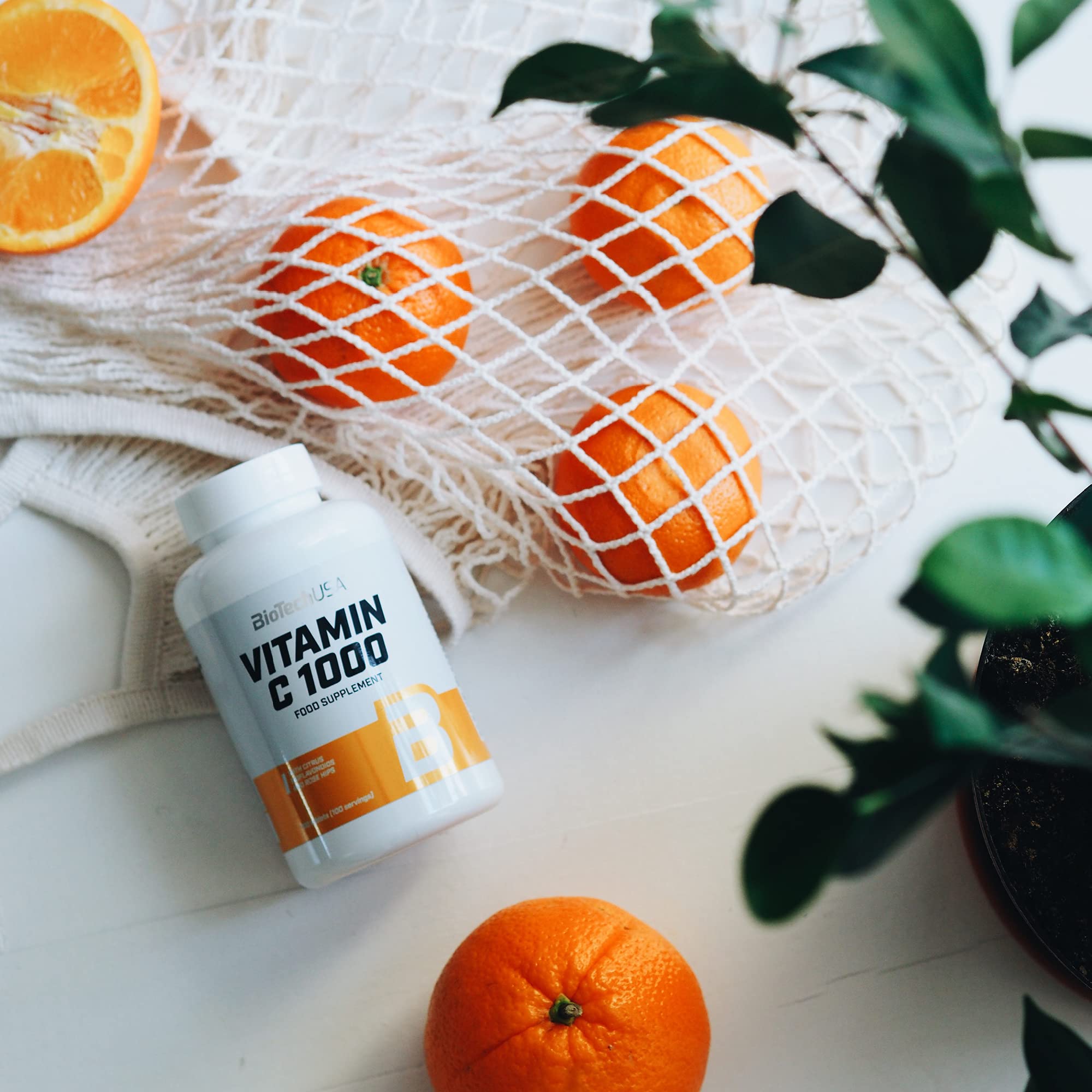 BioTech USA Vitamin C 1000 supplement bottle with fresh oranges for immune boost