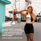 Smiling woman in athletic wear holding Ghost Vegan Protein soy free plant-based protein blend