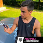 Man in black tank top holding Soccer Supplement Focus Shot with mixed berry flavor