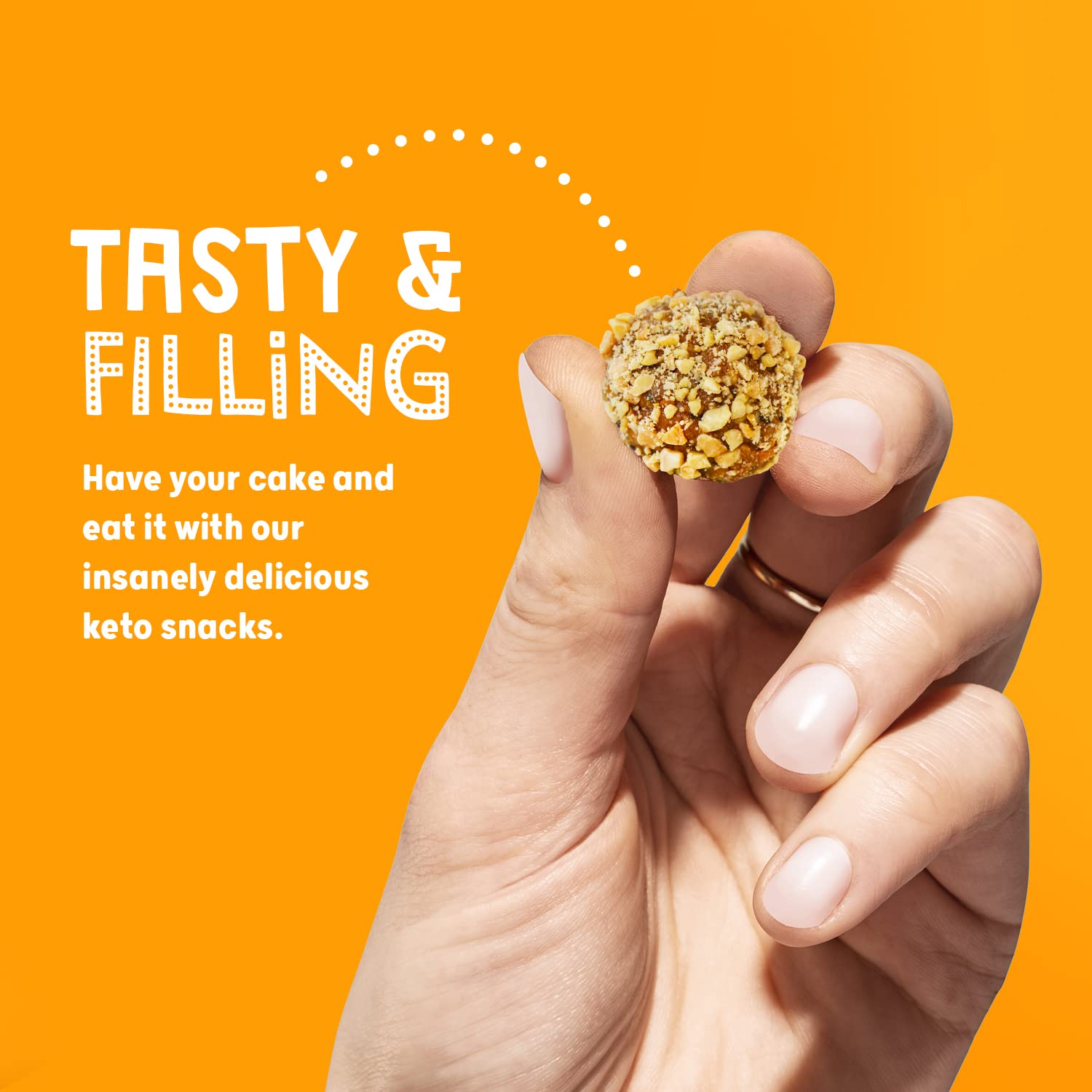 Hand holding a peanut butter keto ball snack from The Protein Ball Co Keto Balls