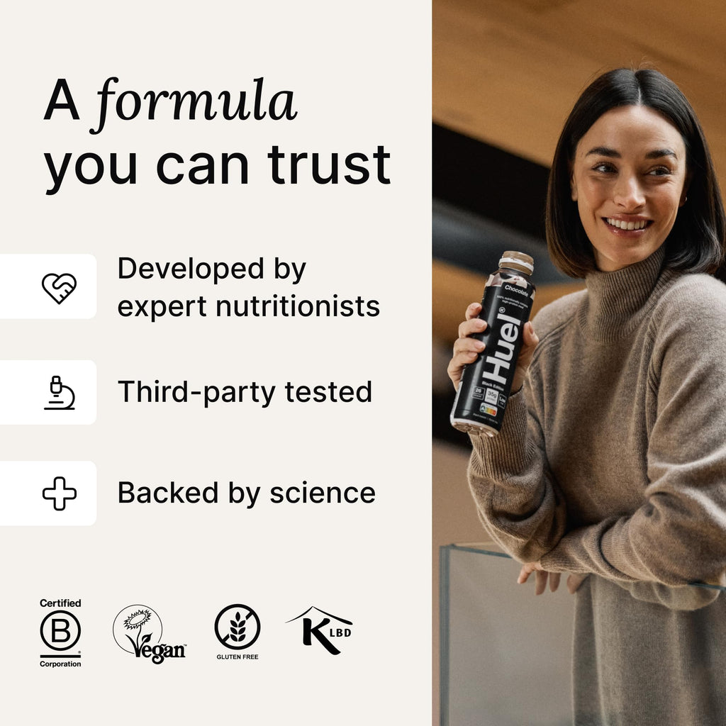 Woman holding Huel Ready-to-Drink Black Edition 8x500ml Chocolate Peanut Butter bottle