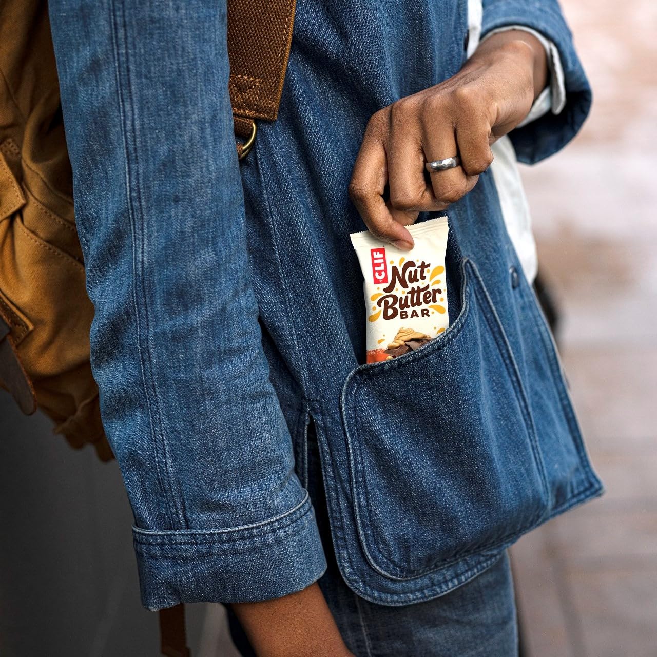 Clif Nut Butter Bar with creamy nut butter, held in denim pocket for on-the-go energy