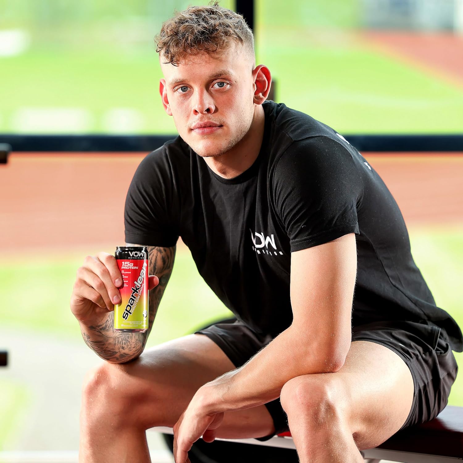 Man in athletic wear holding VOW Nutrition Sparklean Protein Drink with high-quality vegan protein
