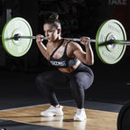 Woman doing a barbell squat with Scitec Nutrition Proteinissimo Prime chocolate coating