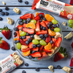 A bowl of mixed fruit salad with Novo Protein Wafer Bar for nutrition Novo Protein