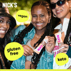 Three smiling women holding NICK’S NUT BAR vegan, gluten-free, keto snack bars with cocoa butter