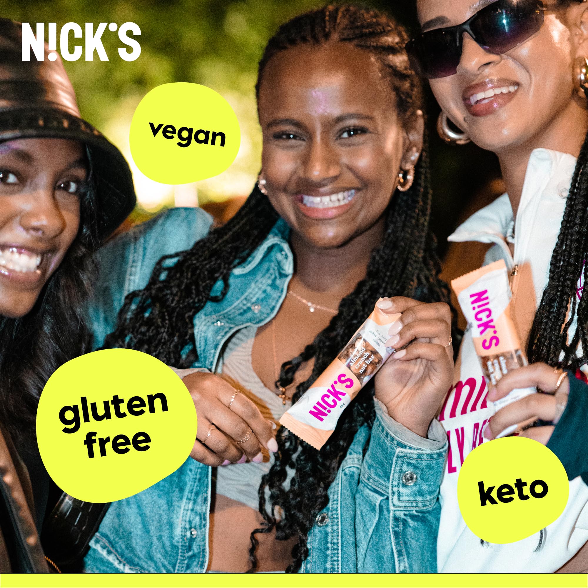 Three smiling women holding NICK’S NUT BAR vegan, gluten-free, keto snack bars with cocoa butter