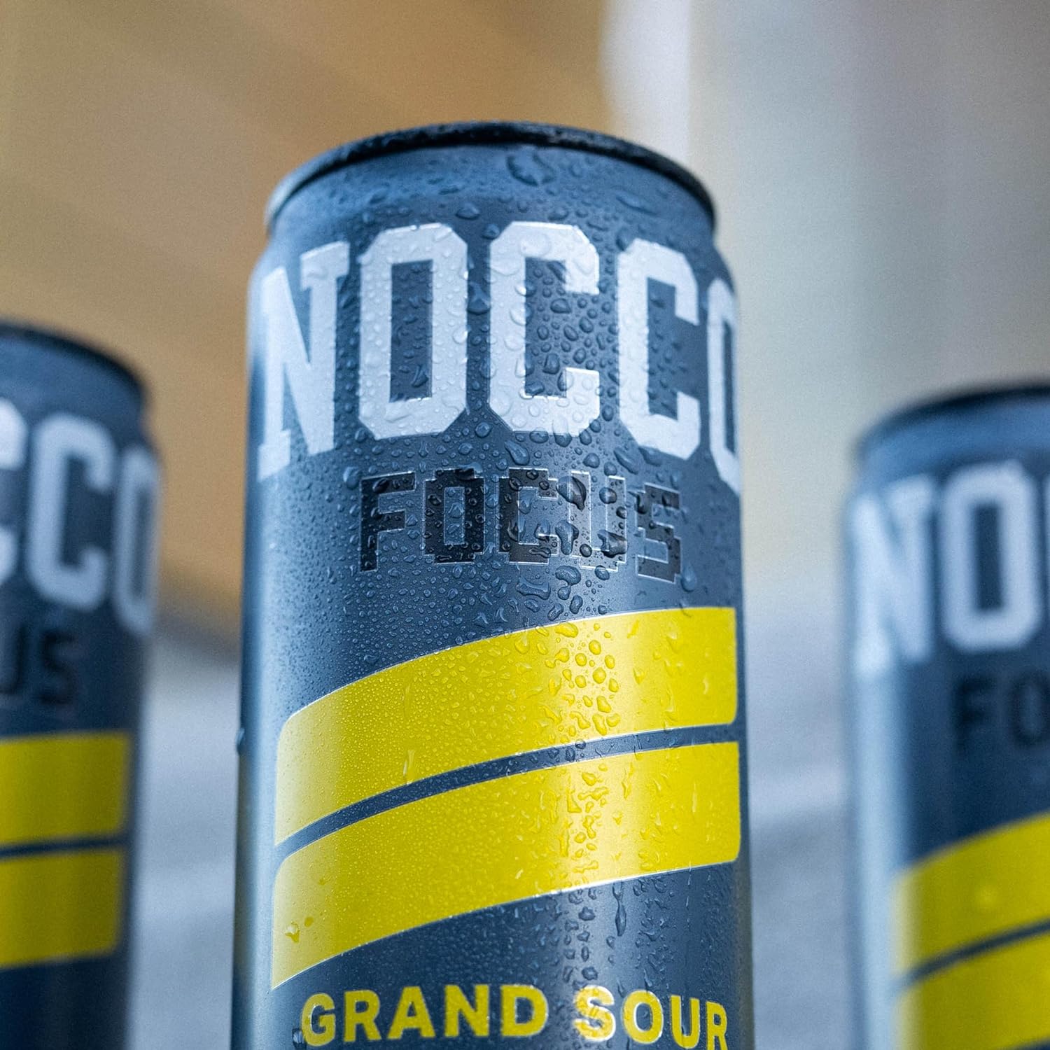 Nocco Focus sugar free energy drink can with dark gray color yellow stripes and condensation