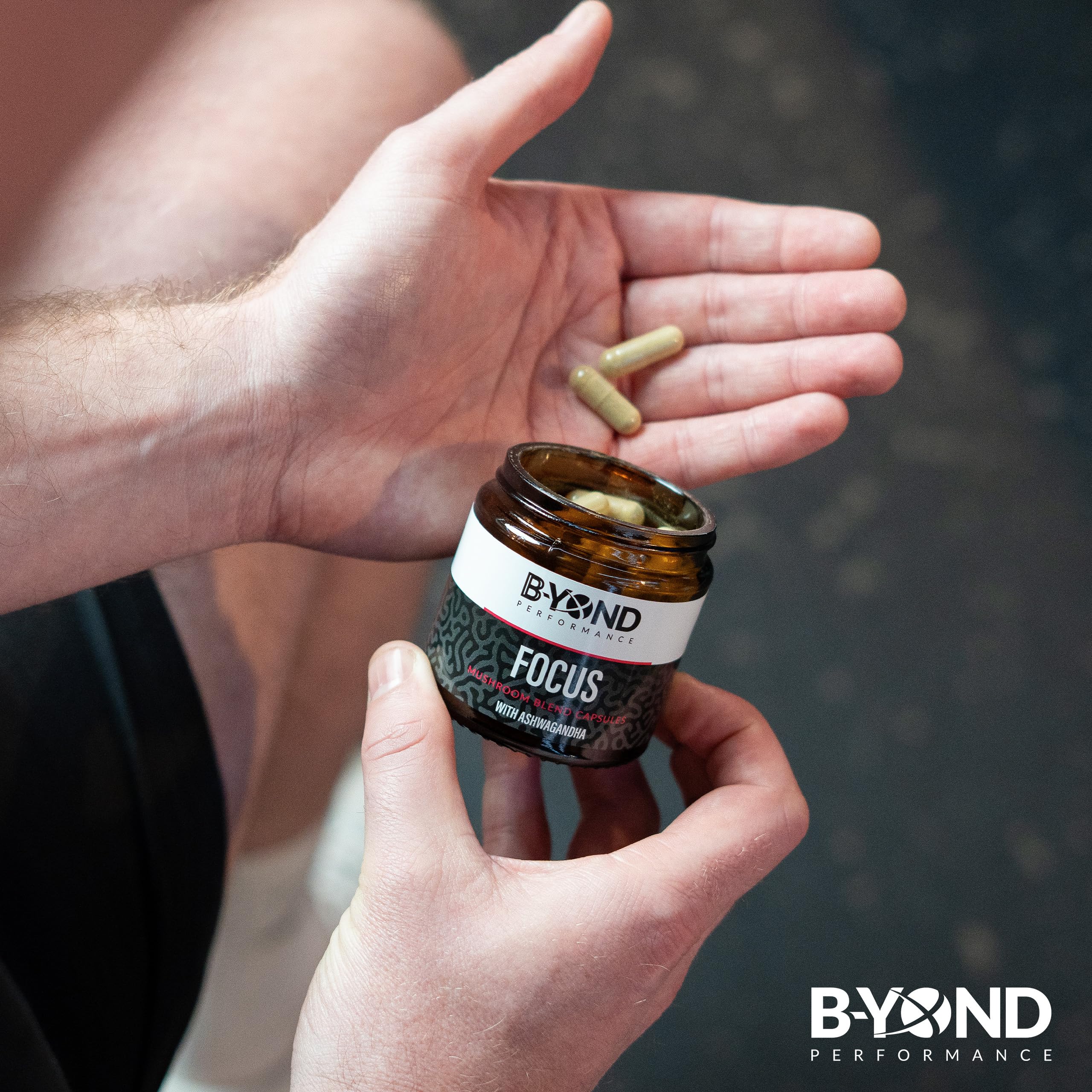 Person holding BYOND PERFORMANCE Focus Mushroom Capsules for mental clarity and focus