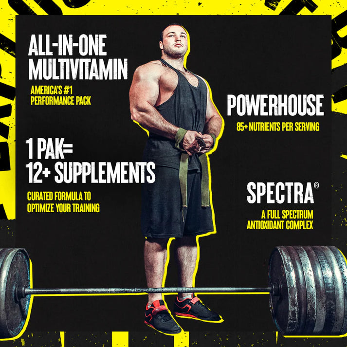 Muscular man with animal pak great-tasting powder supplement standing over barbell