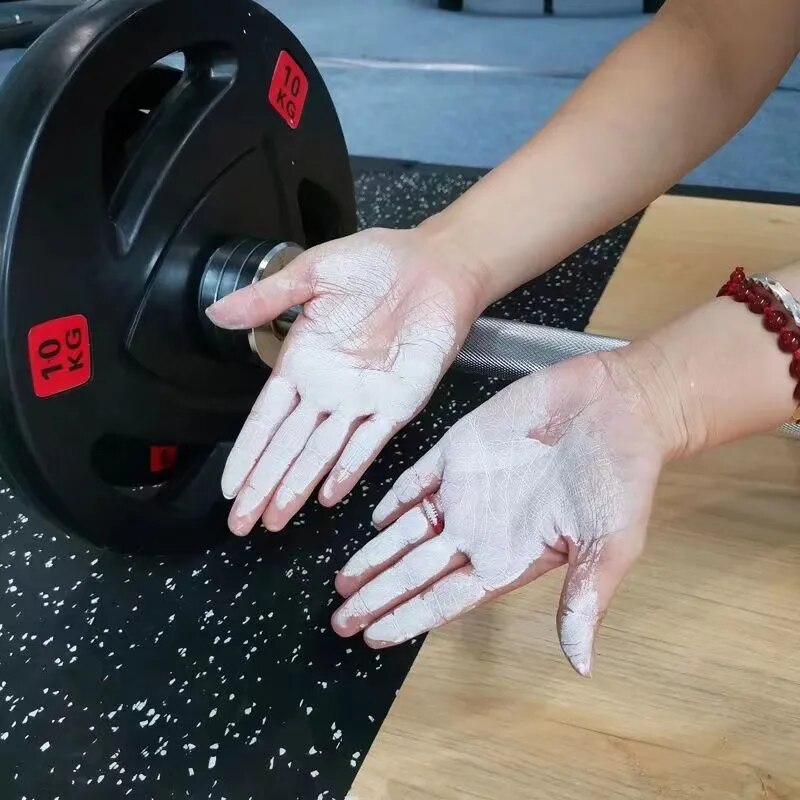 Hands coated in white gym chalk with AK-47 Labs Mega Grip Liquid Chalk 250ml