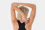 Blonde woman doing triceps stretch with Vilgain Grass-Fed Collagen Peptides for skin elasticity
