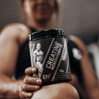 Black tub of DY Nutrition Creatine Monohydrate for muscle growth and physical performance