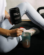 Person preparing Vilgain Pre-Workout 2.0 supplement for workout session