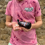 Person holding AK-47 Labs Mega Grip Liquid Chalk 250ml with white chalk in hand