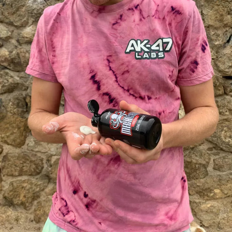 Person holding AK-47 Labs Mega Grip Liquid Chalk 250ml with white chalk in hand