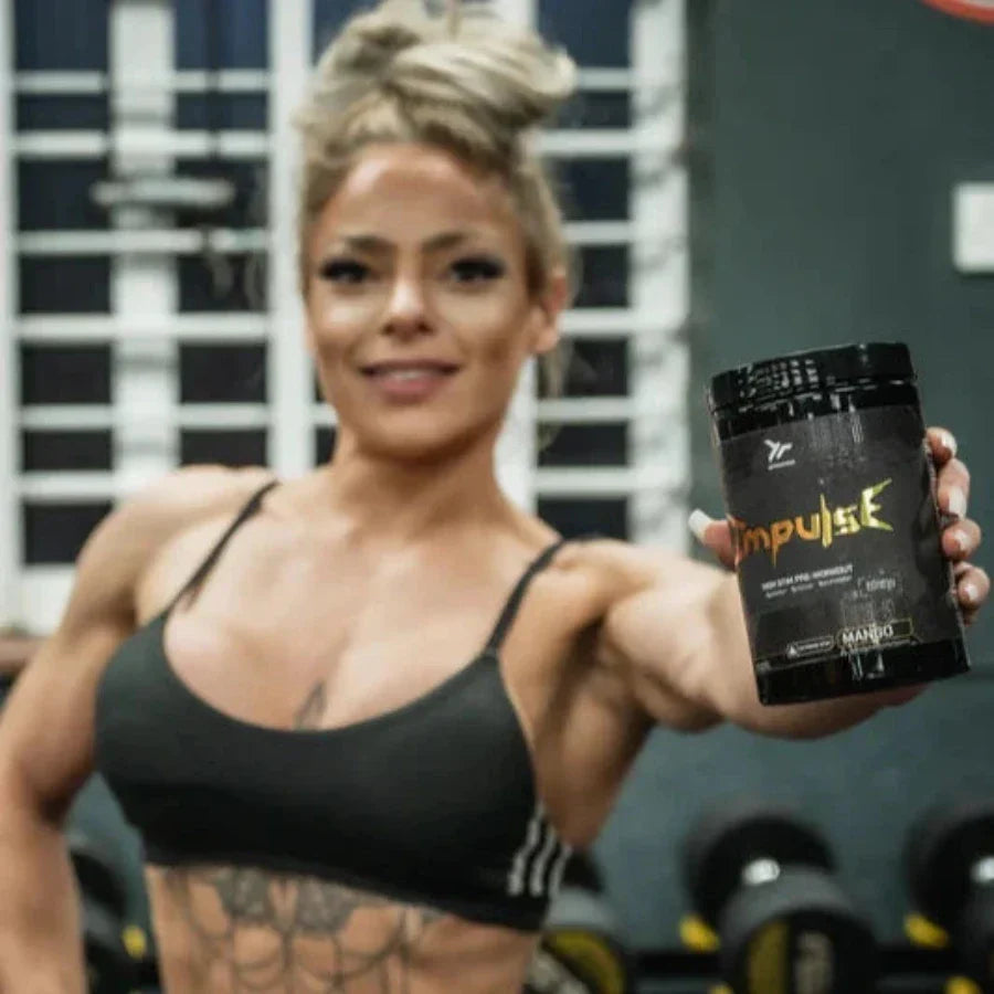 Woman in sports bra holding Endgame Impulse pre-workout for laser-sharp focus and energy
