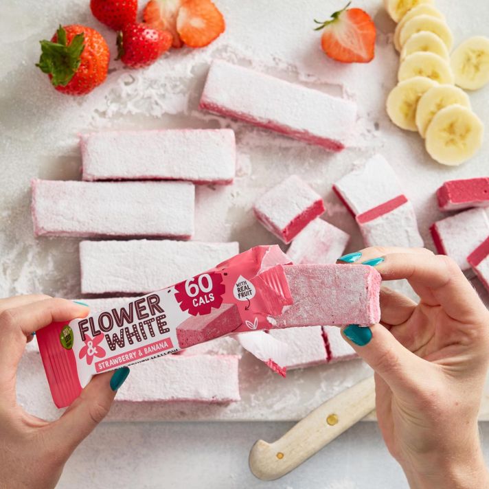 Pink Flower & White Fruity Mallow bar partially unwrapped with delicious strawberry flavor