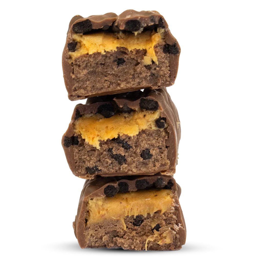 Stack of Per4m Protein Bar with orange filling and cookie topping, super tasty snack