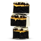 Per4m Protein Bar featuring stacked dark chocolate fudge brownies with peanut butter and white chocolate topping