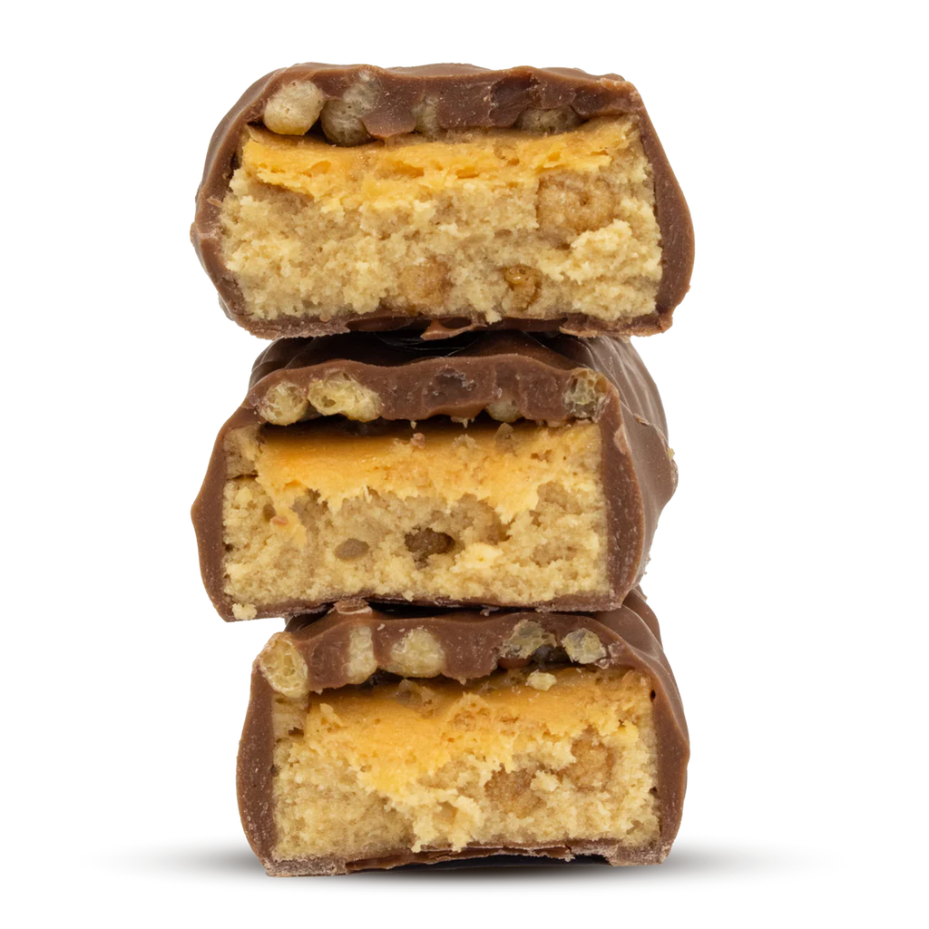 Three Per4m Protein Bars stacked with light-colored nougat and caramel filling