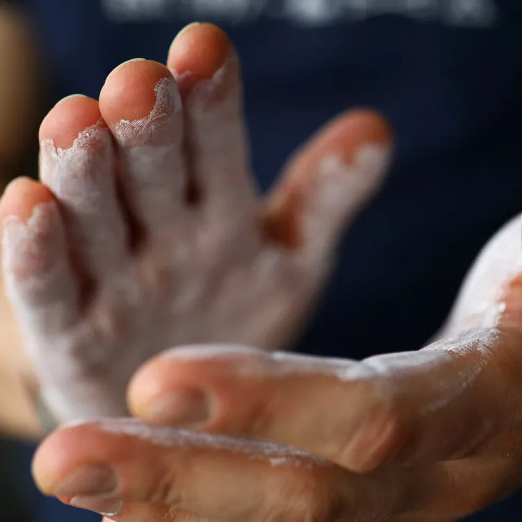 Hands coated in white chalk with AK-47 Labs Mega Grip Liquid Chalk 250ml